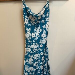 Blue and white floral silky material midi dress with side slit in small.